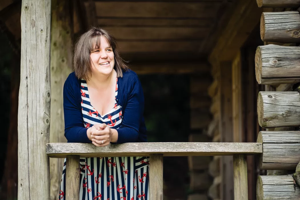 Steph leaning on fence and looking out
