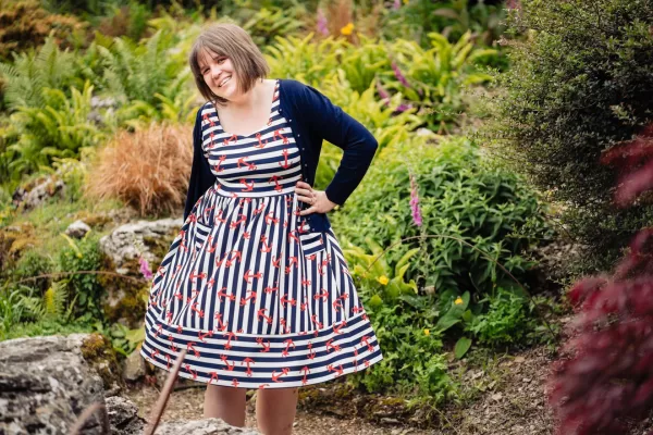 Steph standing in garden with hand on hip